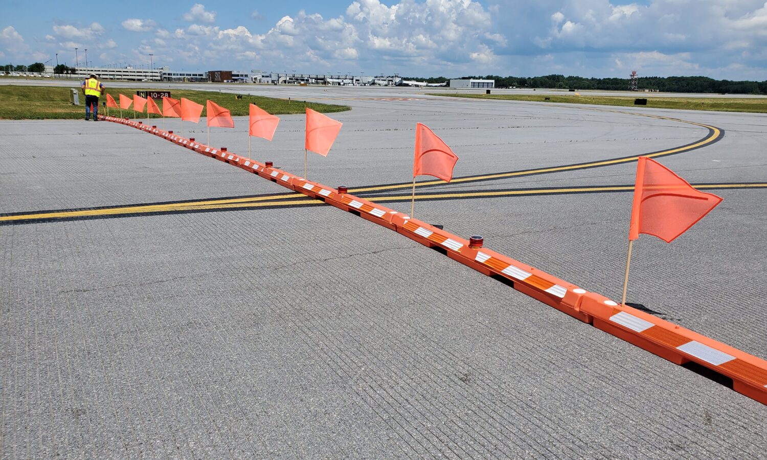 Orange flags and barriers block taxiway