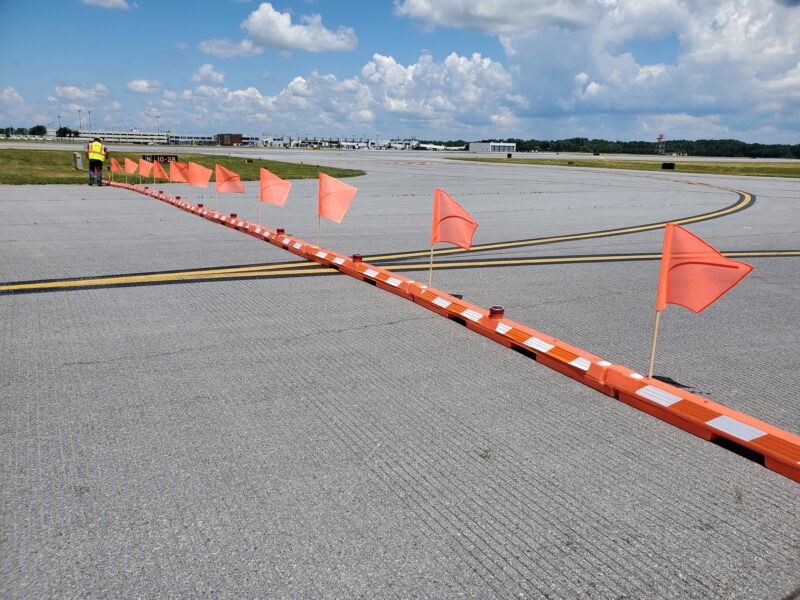 Orange flags and barriers block taxiway