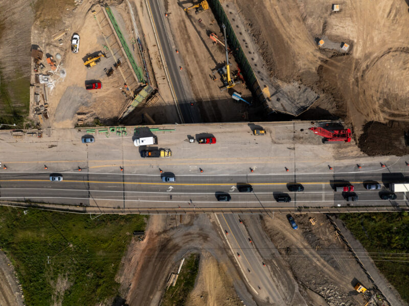 Aerial view: vehicles and equipment on partially built highway.