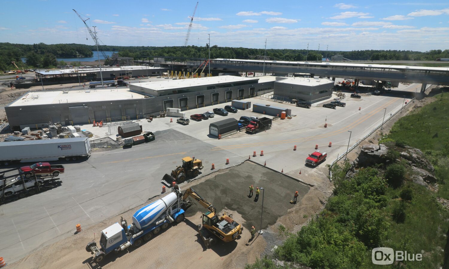 Aerial view: Construction site near road and large industrial buildings