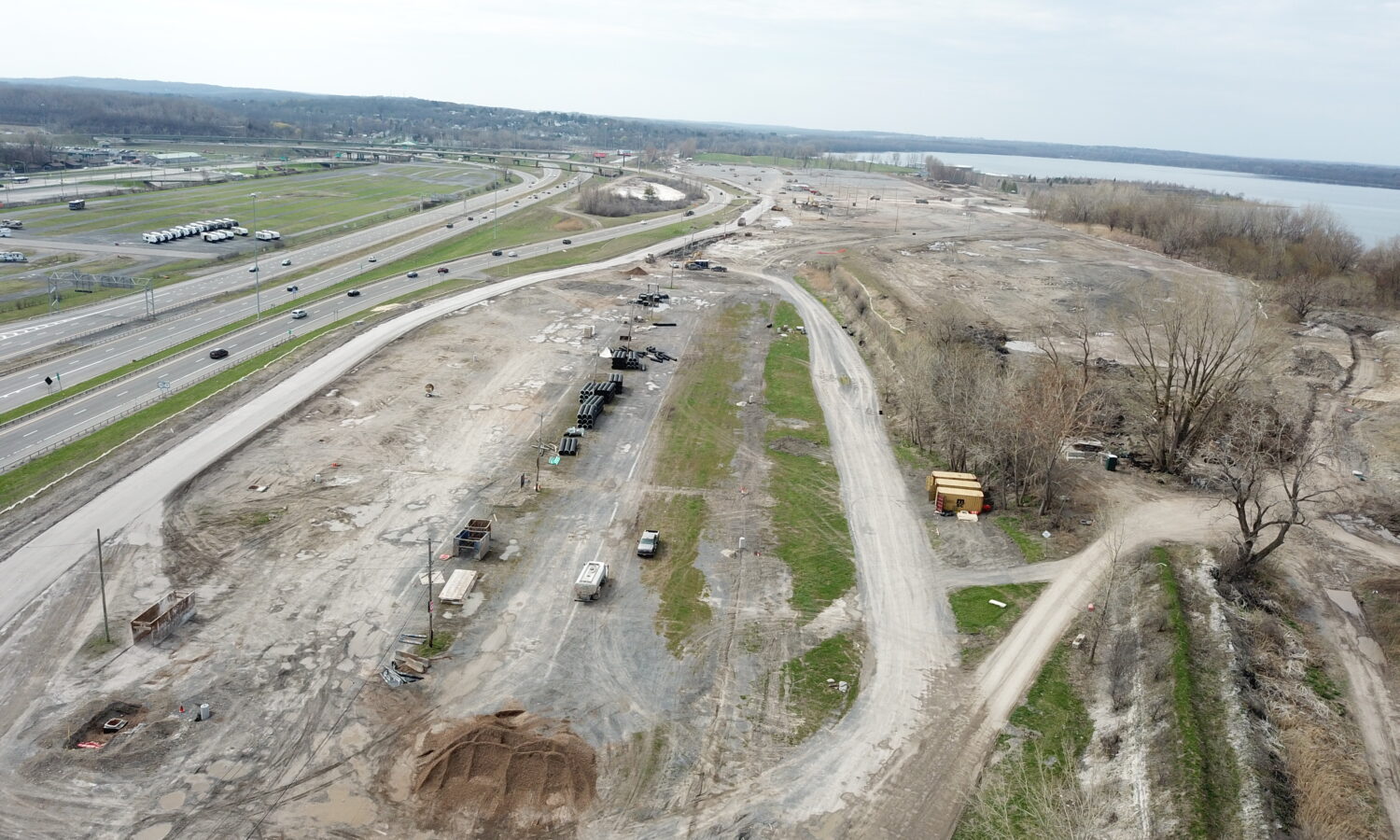 Aerial view: barren construction site by highway