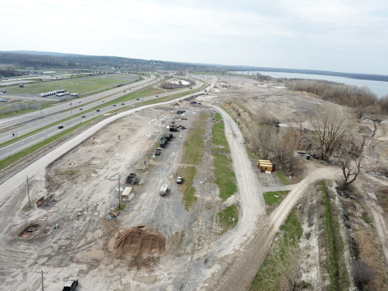 Aerial view: barren construction site by highway